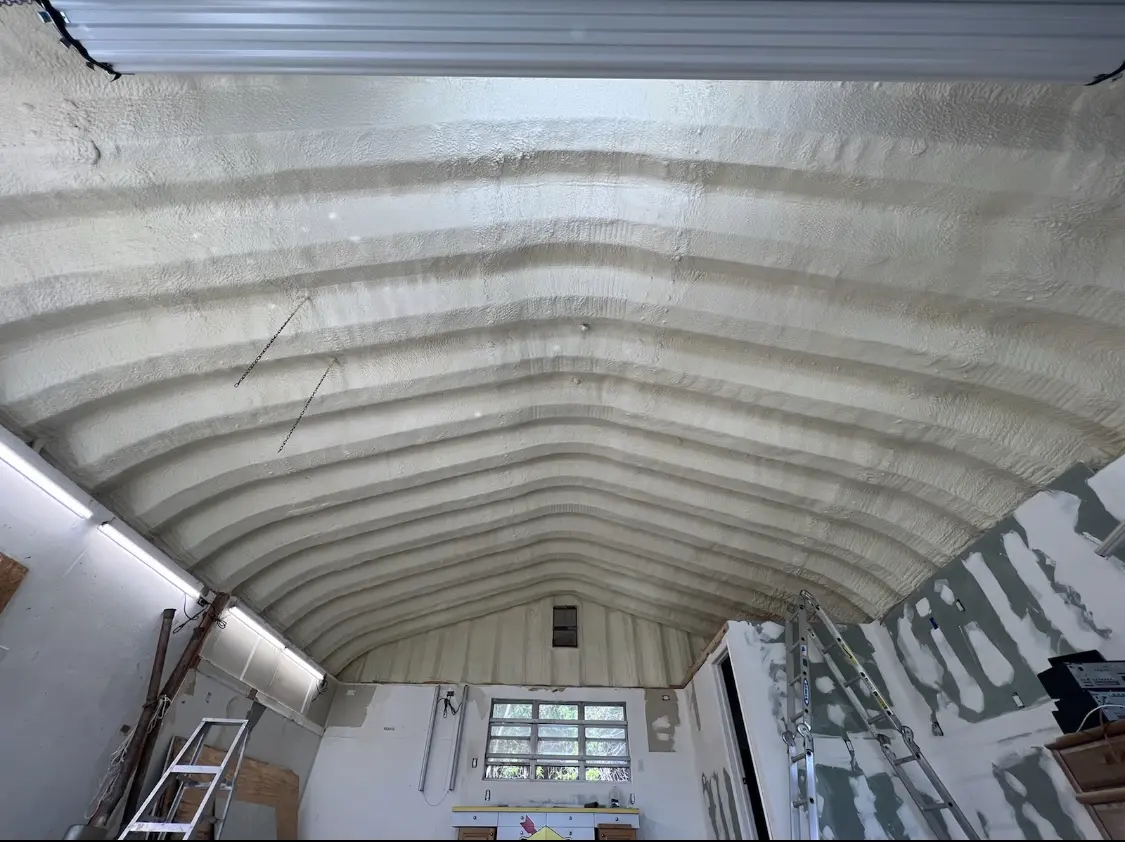 Spray polyurethane foam applied to the underside of a metal roof deck in Crestwood